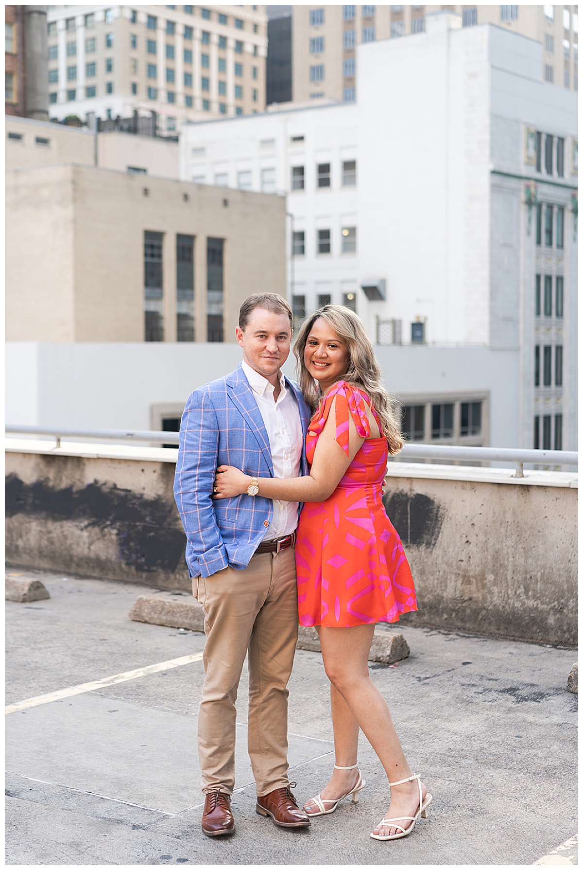 Couple hold each other close on the rooftop showing one of the Best Engagement Photo Locations in Houston