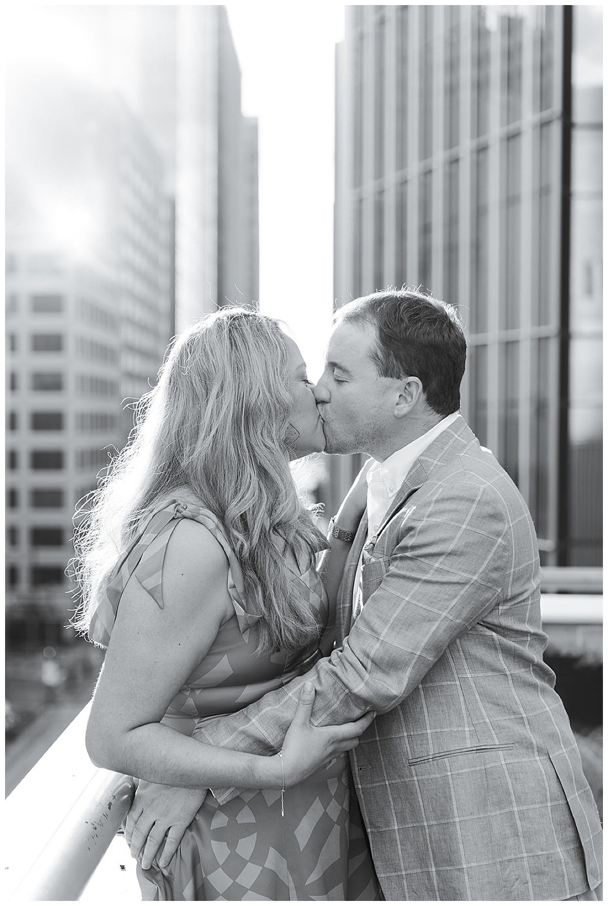 Couple share a kiss on the rooftop Swish & Click Photography