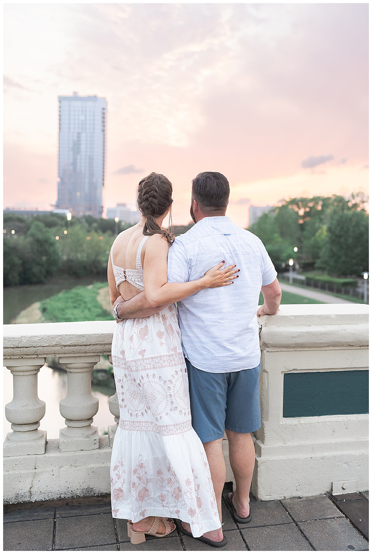 Couple hold each other close admiring the skyline showing one of the Best Engagement Photo Locations in Houston