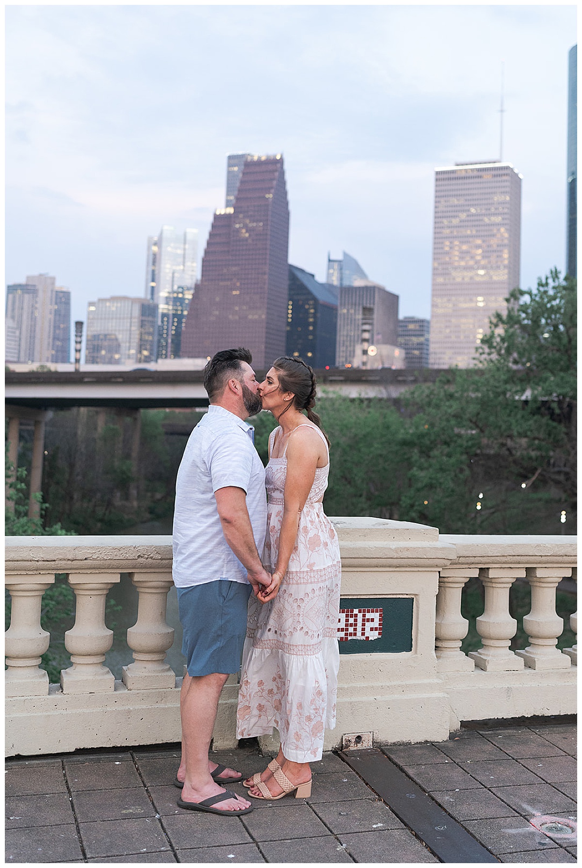 Man and woman share a kiss showing one of the Best Engagement Photo Locations in Houston