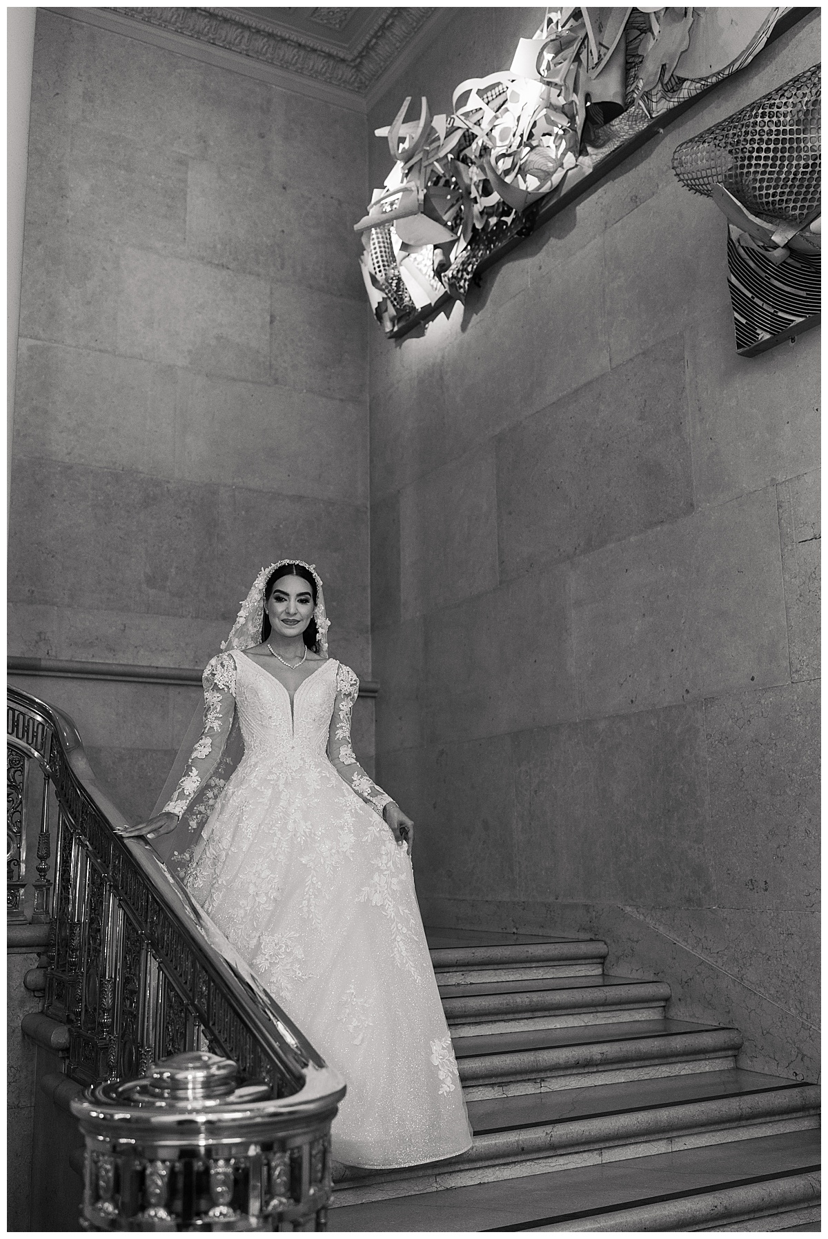 Woman walks down the staircase in a bridal gown by Toronto's Best Wedding Photographers