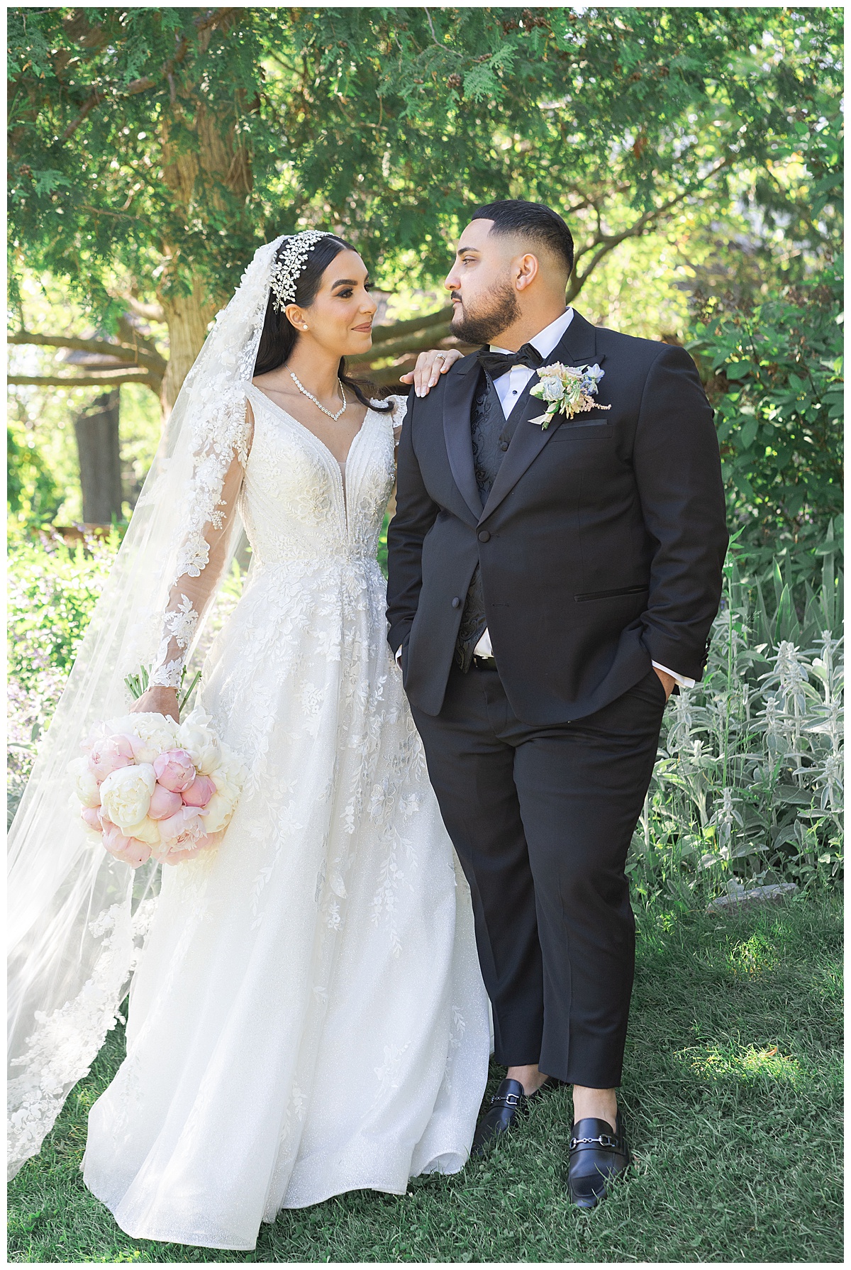 Bride and groom smile at one another by Swish & Click Photography