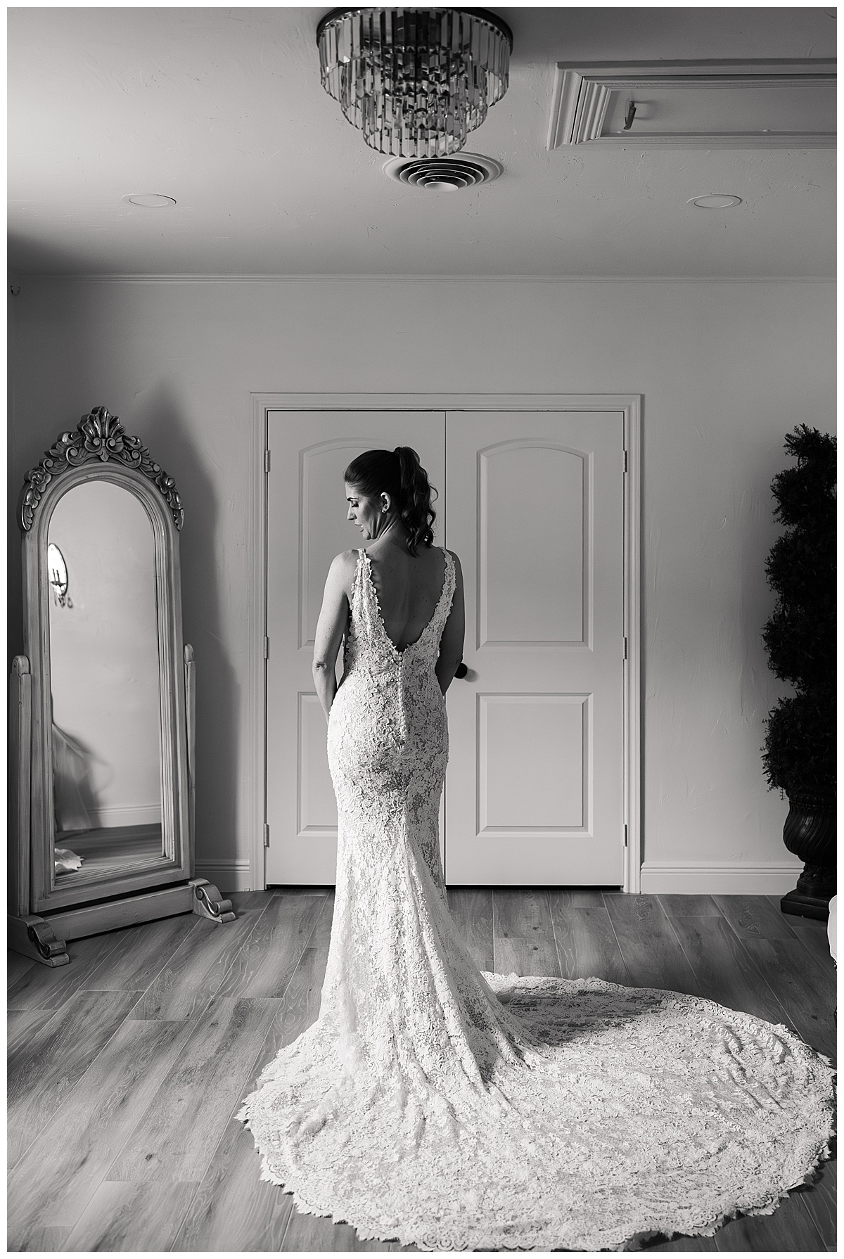 Bride looks over her shoulder wearing a wedding gown by Houston’s Best Wedding Photographers 