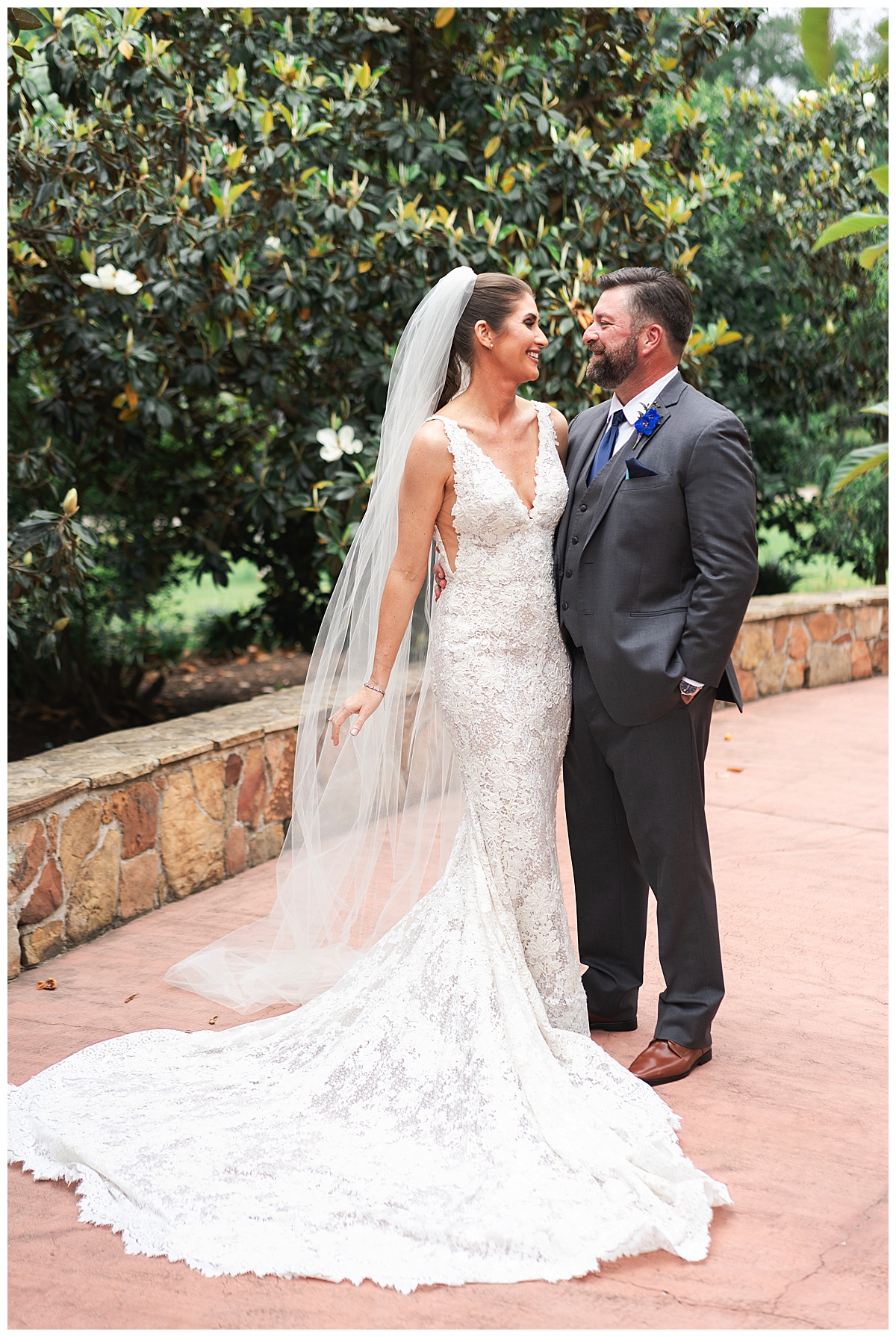 Man and woman smile at one another by Madera Estates Wedding Photographer