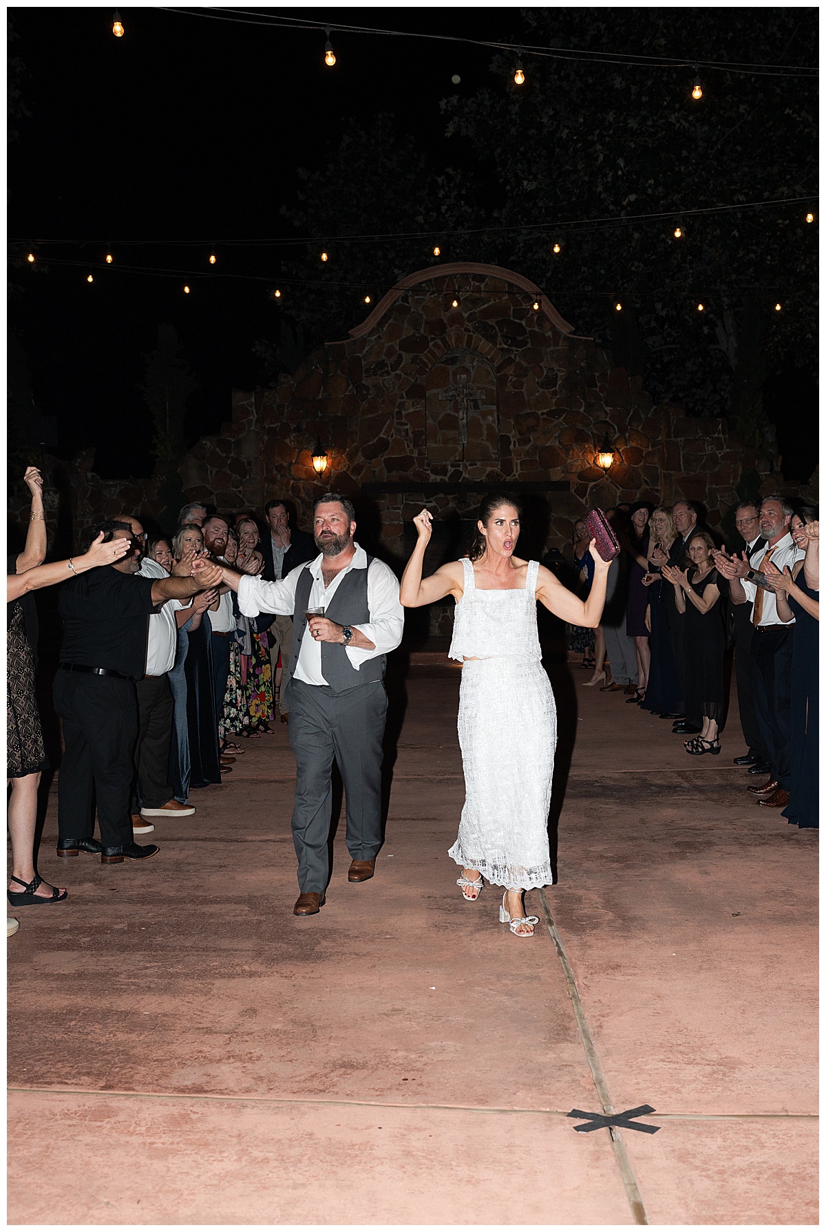 Couple makes their grand exit by Madera Estates Wedding Photographer