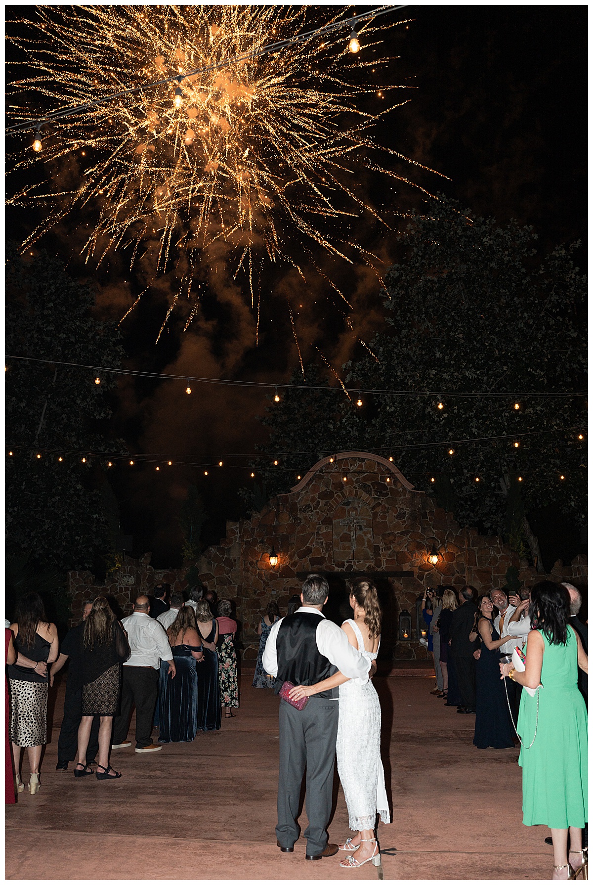 Husband and wife enjoy the fireworks by Madera Estates Wedding Photographer