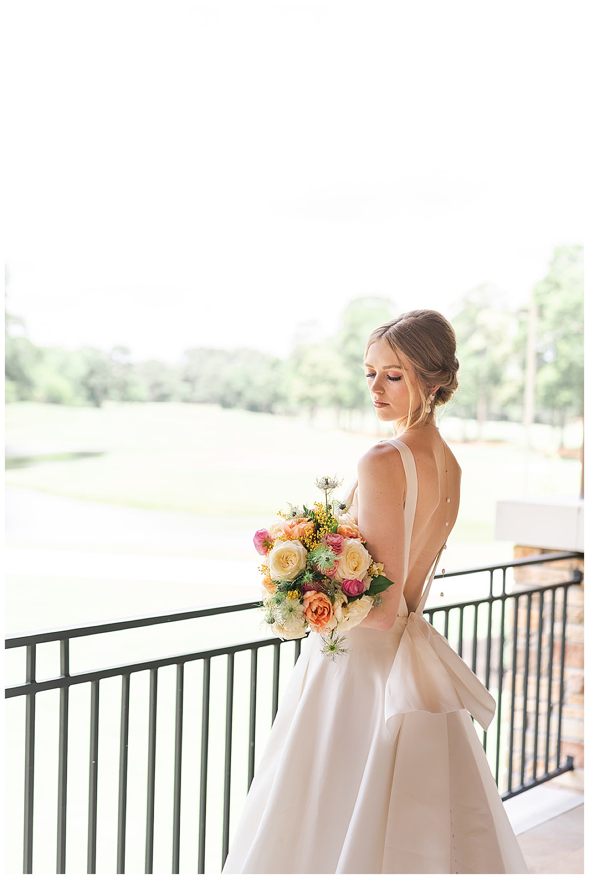 Woman holds wedding bouquet for Swish & Click Photography