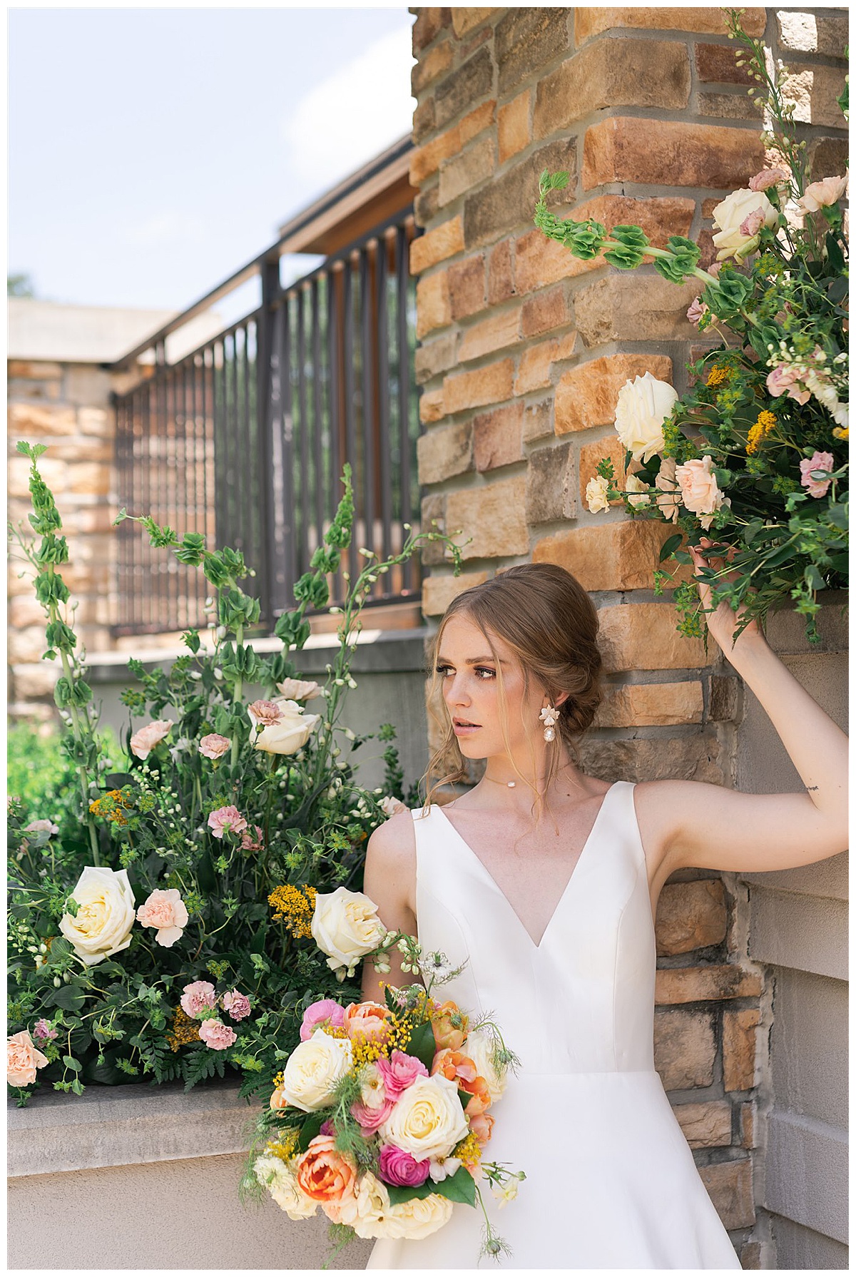 Bride stands under floral installation by Swish & Click Photography