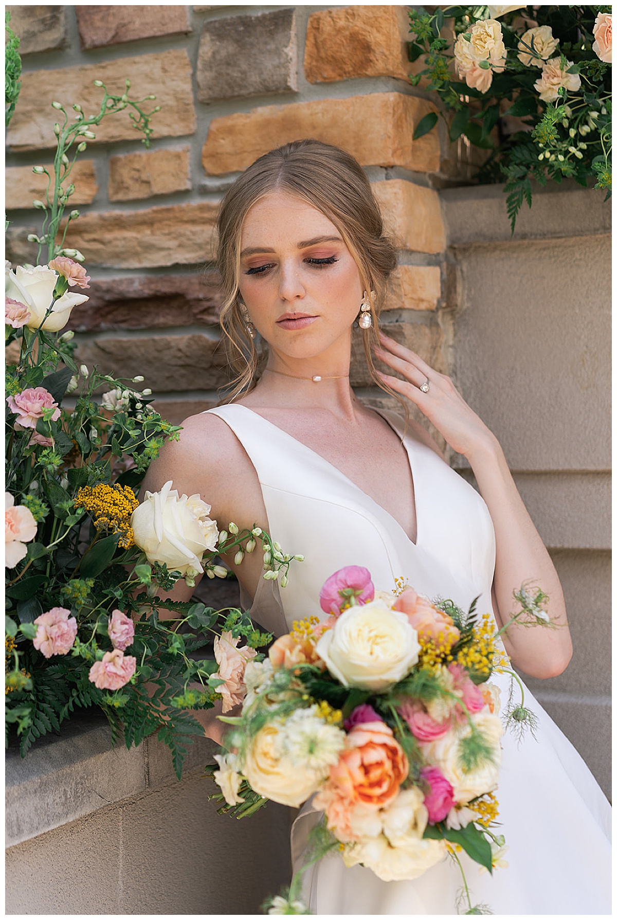 Bride stands near floral installation at The Woodlands Country Club