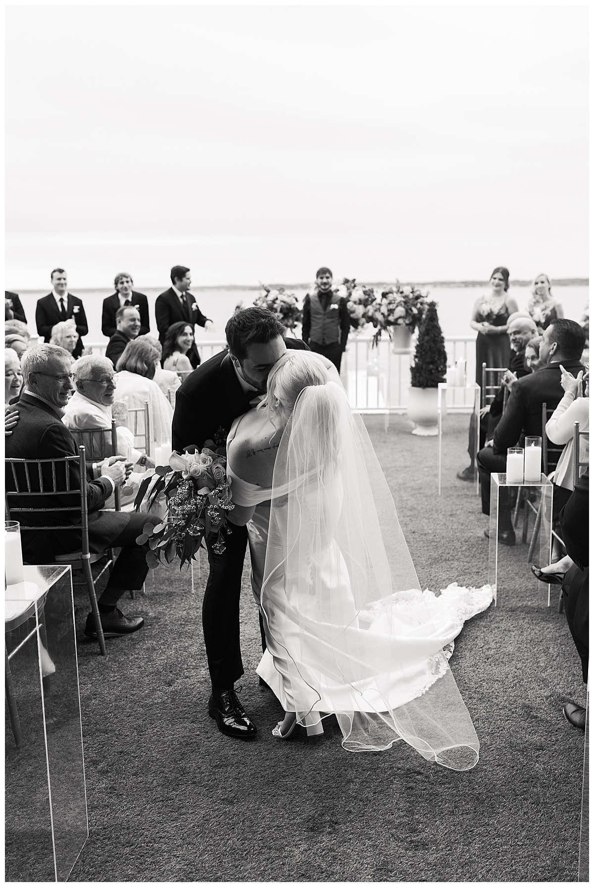 Bride and groom share a kiss after wedding ceremony by Swish & Click Photography