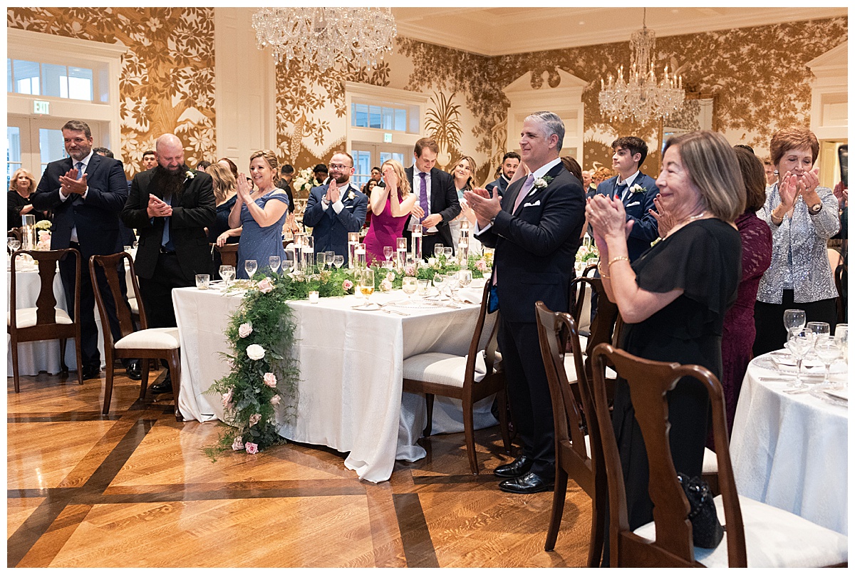 Wedding guest clapping in celebration of the bride and groom finishing their first dance as husband and wife captured by Swish and Click Photography