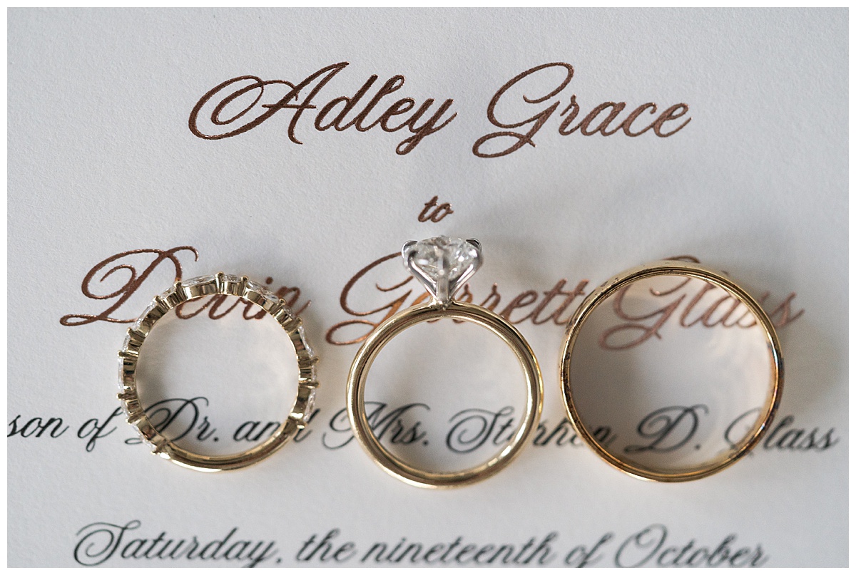 Wedding rings and wedding invitation to showcase details of wedding day photographed by Swish & Click Photography