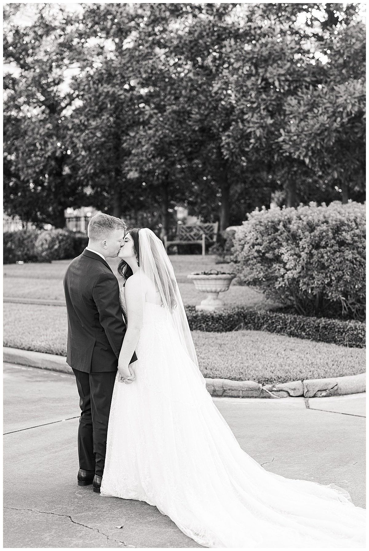 Bride and groom enjoy a kiss in black and white captured by Swish and Click Photography