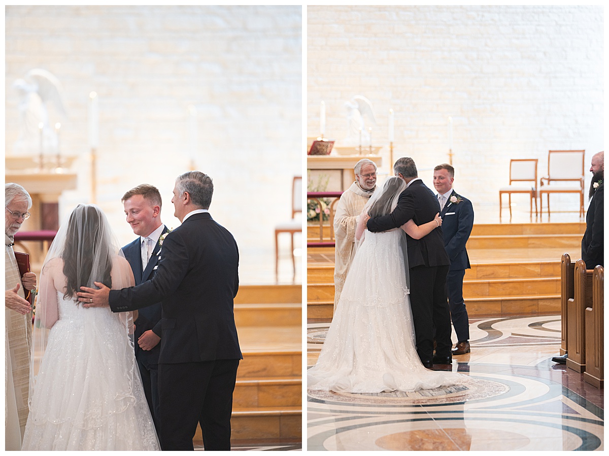 Father of bride giving hugs as he reaches end of the aisle photographed by Swish & Click Photography