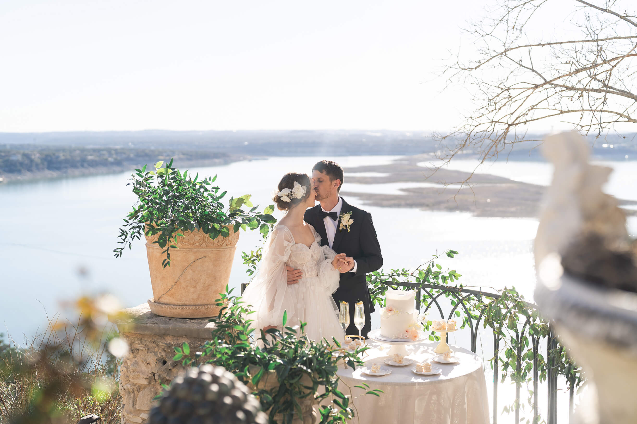 couple kisses while cutting the wedding cake by Houstons best wedding photographers Swish and Click