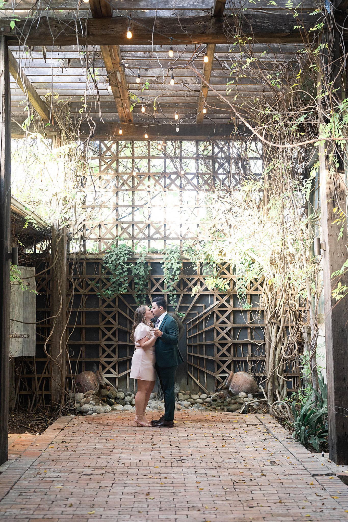 couple kiss during their McKinney Texas engagement session with Swish and Click Photography