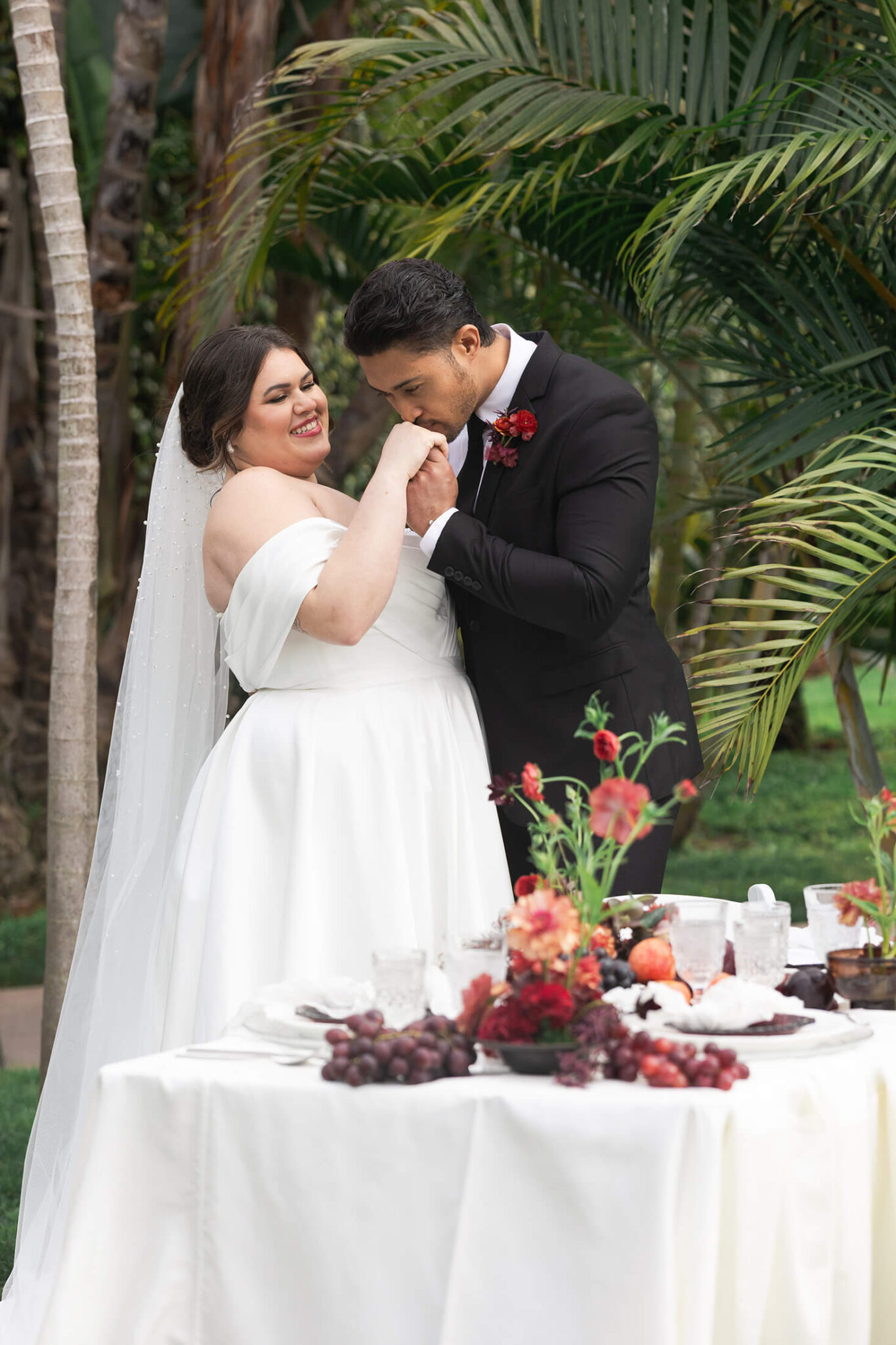 A curvy bride at a 45-degree angle from the camera as she and her groom share private vows.