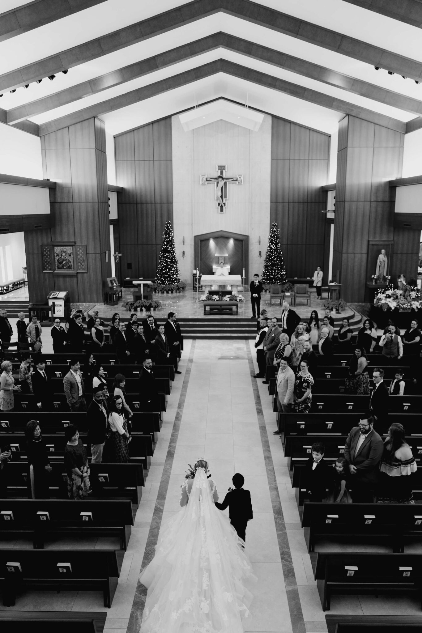 bride walks down the aisle on her wedding day with her son by Swish and Click Photography