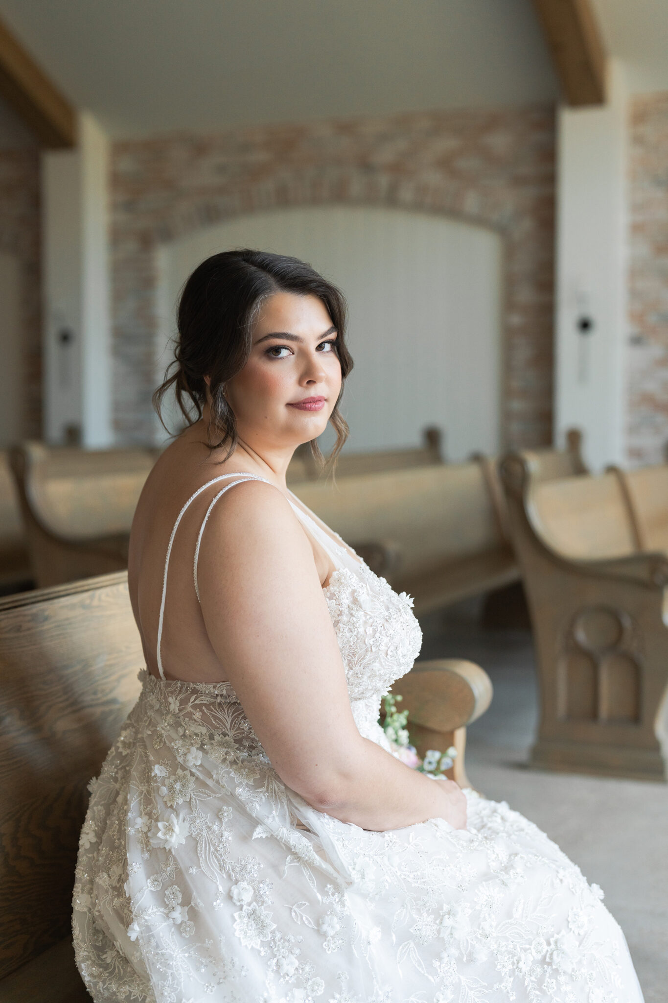 bride sits in the pews of the chapel at the Blue Magnolia wedding venue in Houston Texas