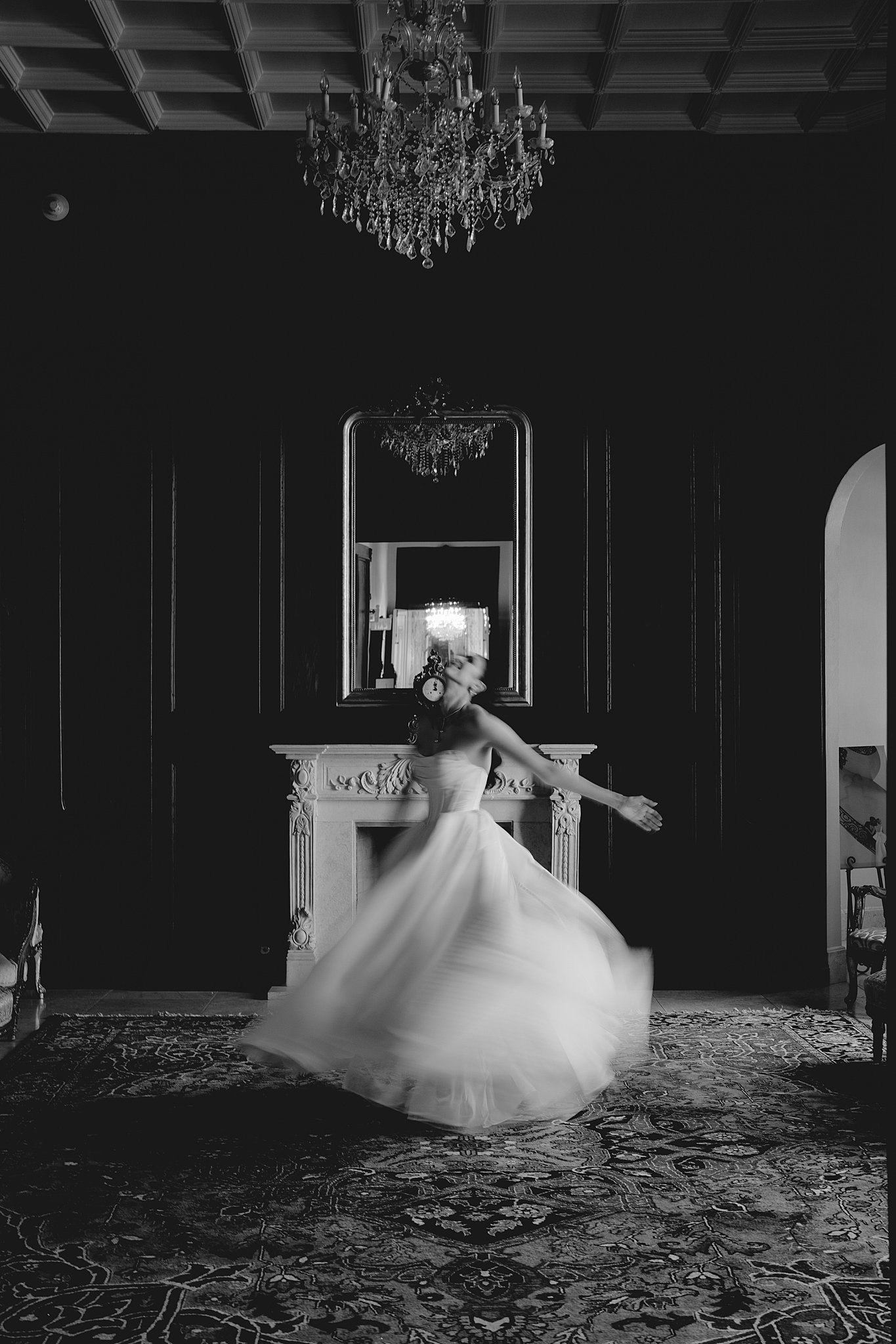 at her bridal session at Chateau Nouvelle a bride dances in the library