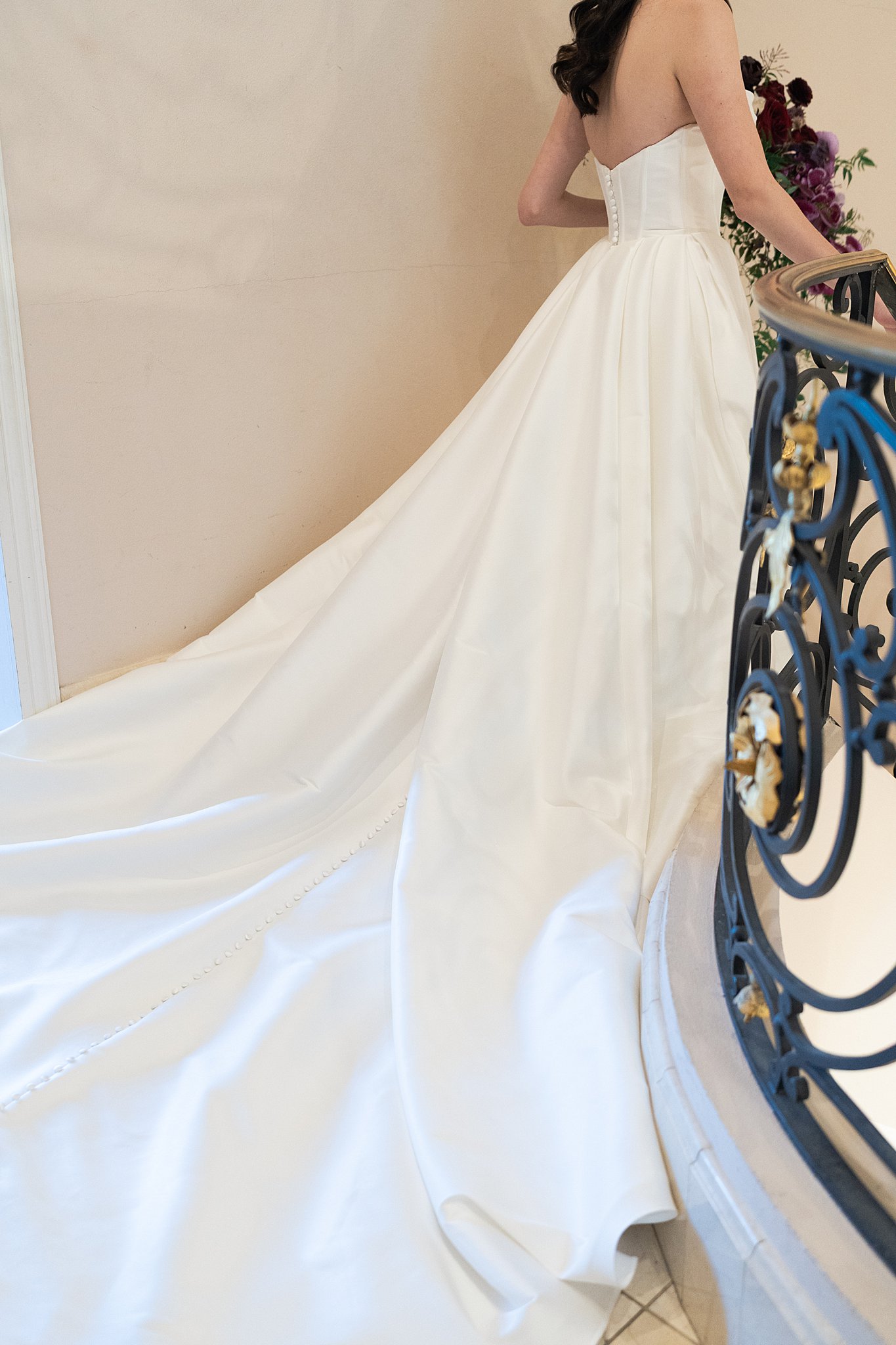bride walks down the staircase at Chateau Nouvelle during her bridal session