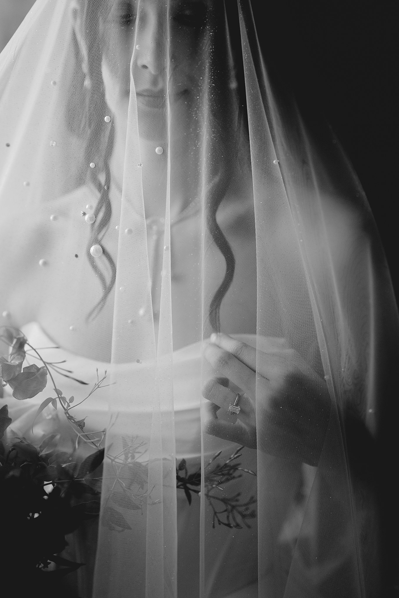 bride waits by a window at Chateau Nouvelle during her bridal session
