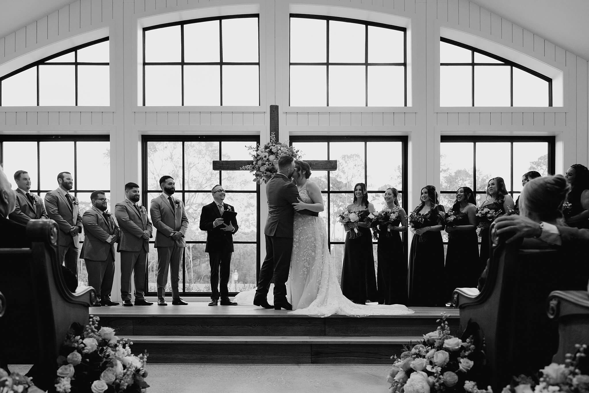 Bride and groom share their first kiss on their wedding day captured by wedding photographer Swish and Click at the Blue Magnolia