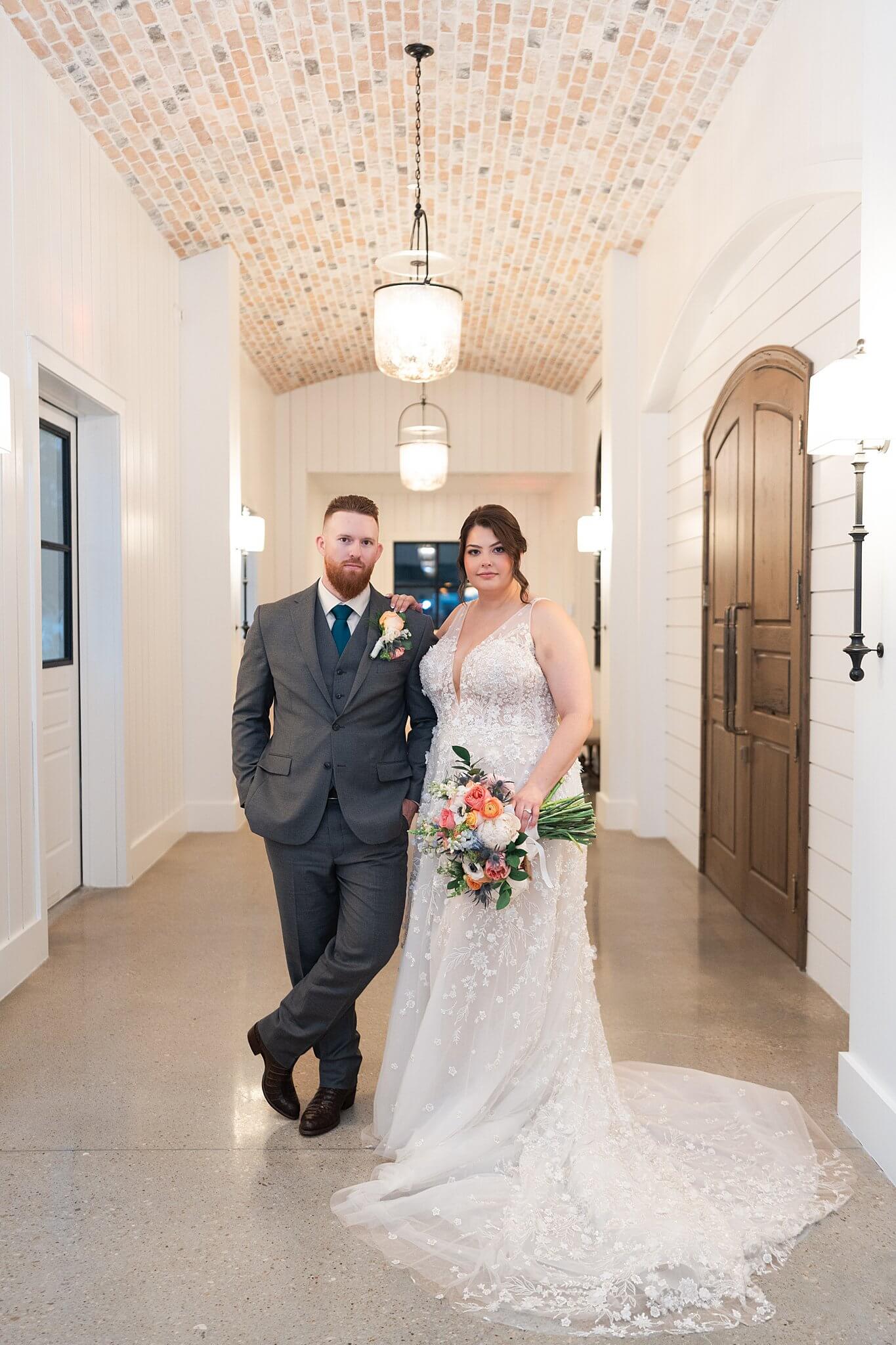 wedding couple pose on their wedding day with Swish and Click Photography at Texas wedding venue the Blue Magnolia
