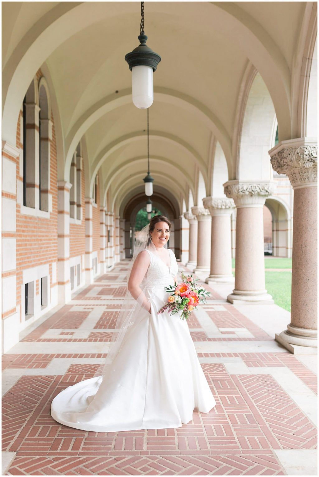 Houston bride poses outside Lovett Hall at Rice University in Houston Texas by Swish and Click Photography